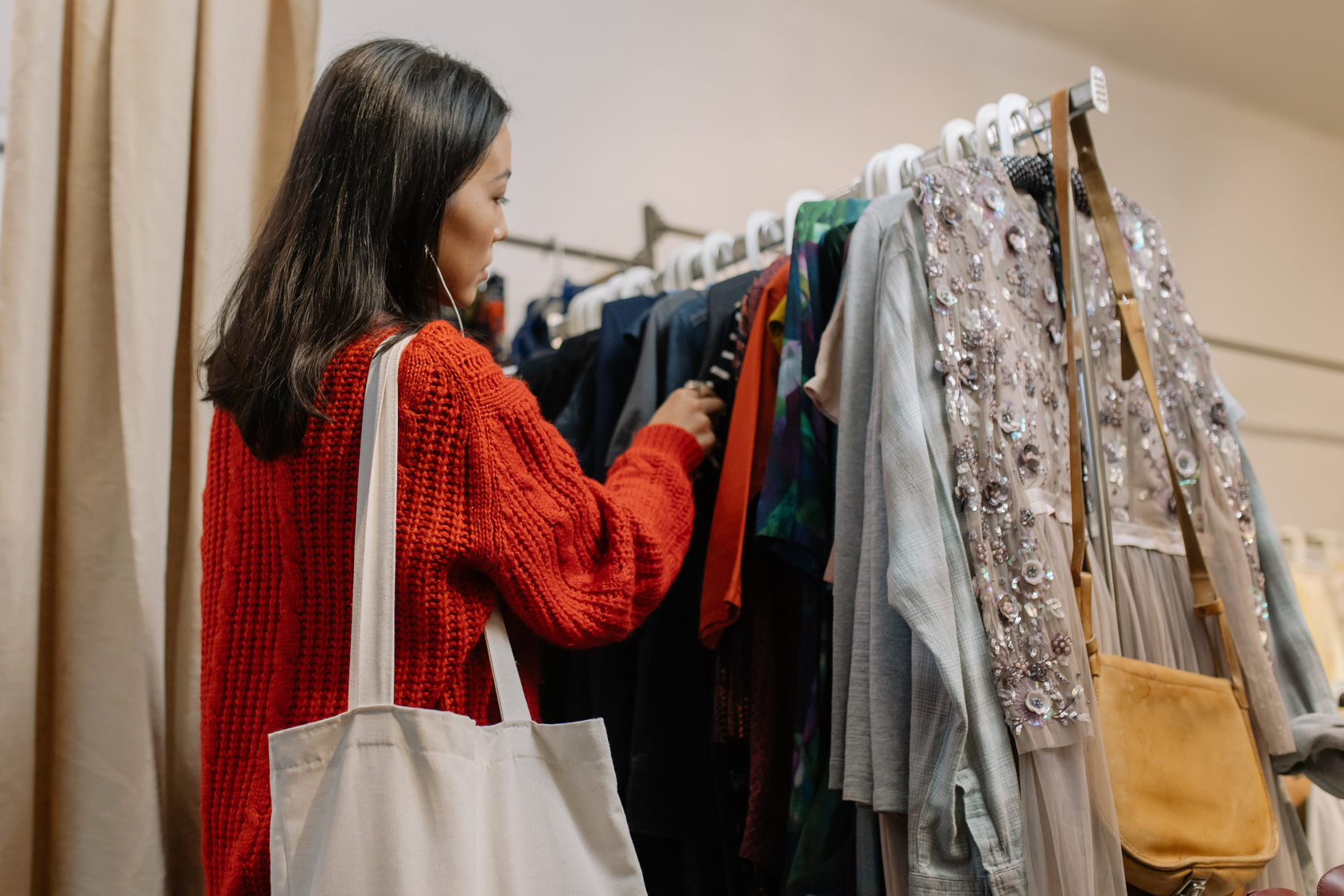 Woman in Red Cardigan Holding White Tote Bag